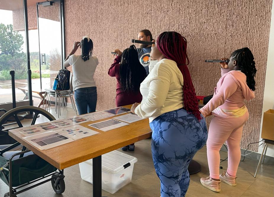 Sponsored KidWind 2023 students enjoying a science demonstration in the Mesa Lab cafeteria.