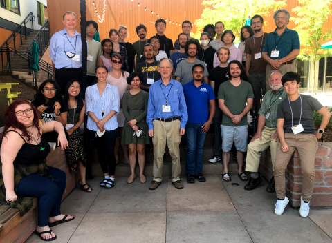 Students and lecturers assembled together outdoors at the Embassy Suites patio area