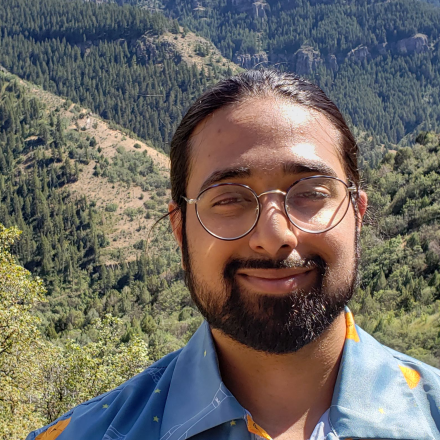 Nir Patel headshot with Boulder foothills background