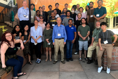 Students and lecturers assembled together outdoors at the Embassy Suites patio area