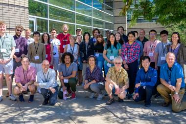 Smiling group of Spectropolarimetry school students and lecturers taken on the outdoor patio at Center Green 1 building.